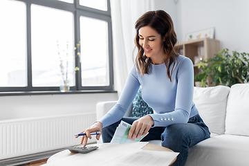 Image showing happy woman counting money at home