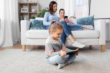 Image showing happy girl with tablet pc and family at home