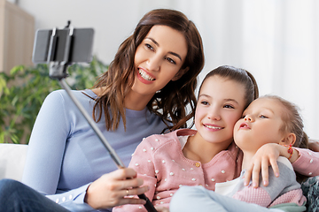 Image showing happy family taking selfie by smartphone at home