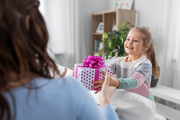 Image showing happy daughter giving present to mother at home