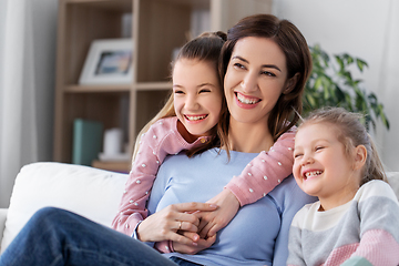 Image showing happy smiling mother with two daughters at home