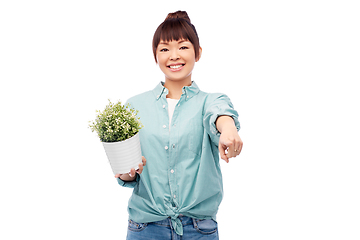 Image showing happy smiling asian woman holding flower in pot