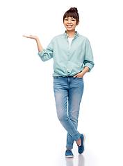 Image showing happy asian woman holding something on her hand