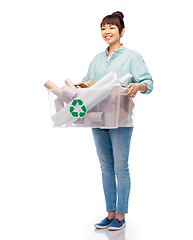 Image showing happy smiling asian woman sorting paper waste