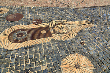 Image showing Unusual pavement with creative pattern from rusty metal details,