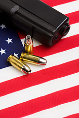 Image showing gun and bullets on flag