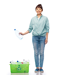 Image showing smiling young asian woman sorting plastic waste