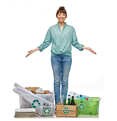 Image showing happy woman sorting paper, metal and plastic waste