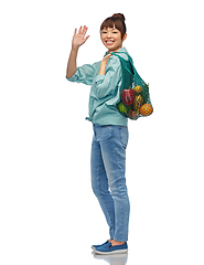 Image showing happy asian woman with food in reusable string bag