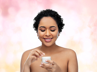 Image showing young african american woman with moisturizer