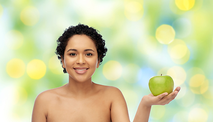 Image showing happy african american woman holding green apple
