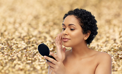 Image showing african american woman looking to mirror