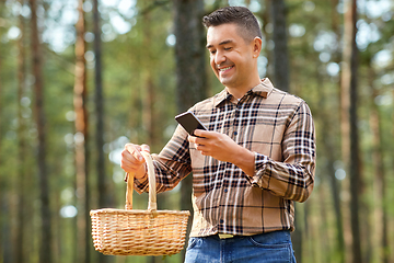 Image showing man using smartphone to identify mushroom