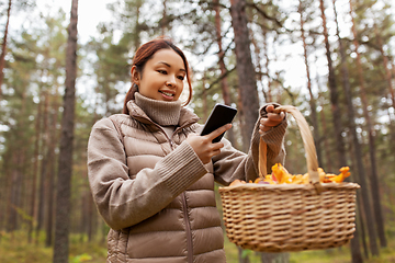 Image showing asian woman using smartphone to identify mushroom