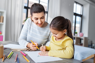 Image showing mother with little daughter drawing at home