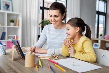 Image showing mother and daughter with tablet pc drawing at home