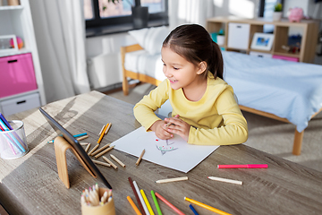 Image showing little girl drawing with coloring pencils at home