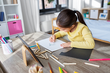 Image showing little girl drawing with coloring pencils at home