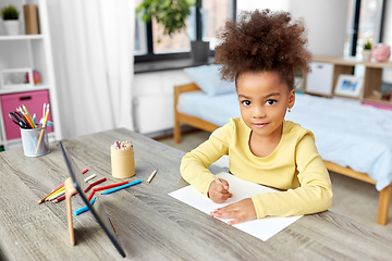 Image showing little girl drawing with coloring pencils at home