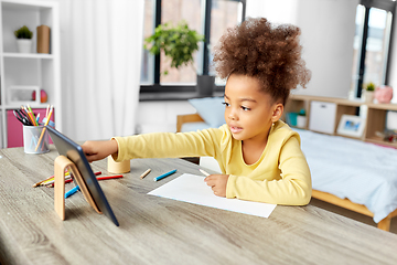 Image showing little african girl with tablet pc drawing at home