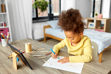 Image showing little girl drawing with coloring pencils at home