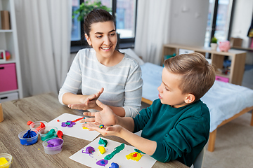 Image showing mother and son playing with modeling clay at home