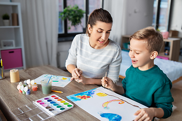 Image showing mother and son with colors drawing at home