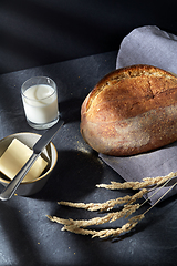 Image showing close up of bread, butter, knife and glass of milk