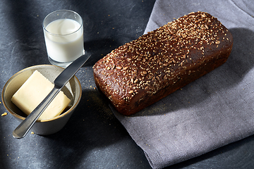 Image showing close up of bread, butter, knife and glass of milk