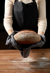 Image showing female baker with homemade bread at bakery