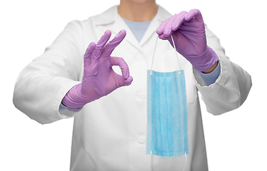 Image showing female doctor with medical mask showing ok gesture