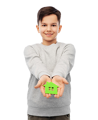 Image showing smiling boy holding green house icon