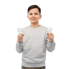 Image showing smiling boy comparing different light bulbs