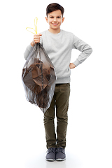 Image showing smiling boy with paper garbage in plastic bag