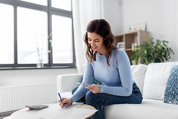 Image showing happy woman counting money at home