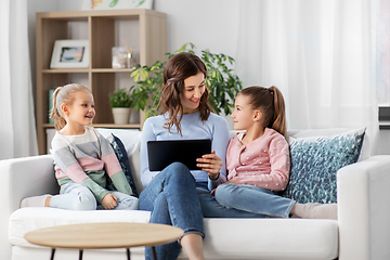 Image showing happy mother and daughters with tablet pc at home