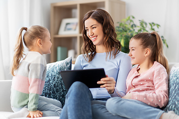 Image showing happy mother and daughters with tablet pc at home