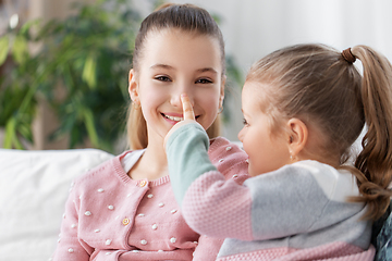 Image showing two happy smiling little girls or sisters at home