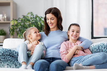 Image showing happy smiling mother with two daughters at home