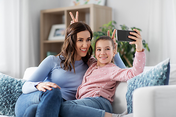 Image showing happy family taking selfie by smartphone at home