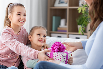 Image showing daughters giving present to happy mother