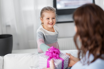 Image showing happy daughter giving present to mother at home