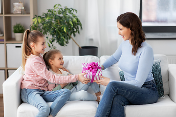 Image showing daughters giving present to happy mother