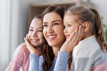 Image showing happy smiling mother with two daughters at home