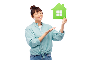 Image showing smiling asian woman holding green house