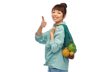 Image showing happy asian woman with food in reusable string bag