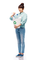 Image showing smiling young woman sorting plastic waste