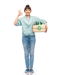 Image showing smiling young asian woman sorting glass waste