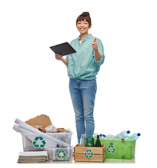 Image showing smiling asian woman with tablet pc sorting waste