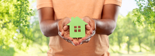 Image showing close up of african man holding green house